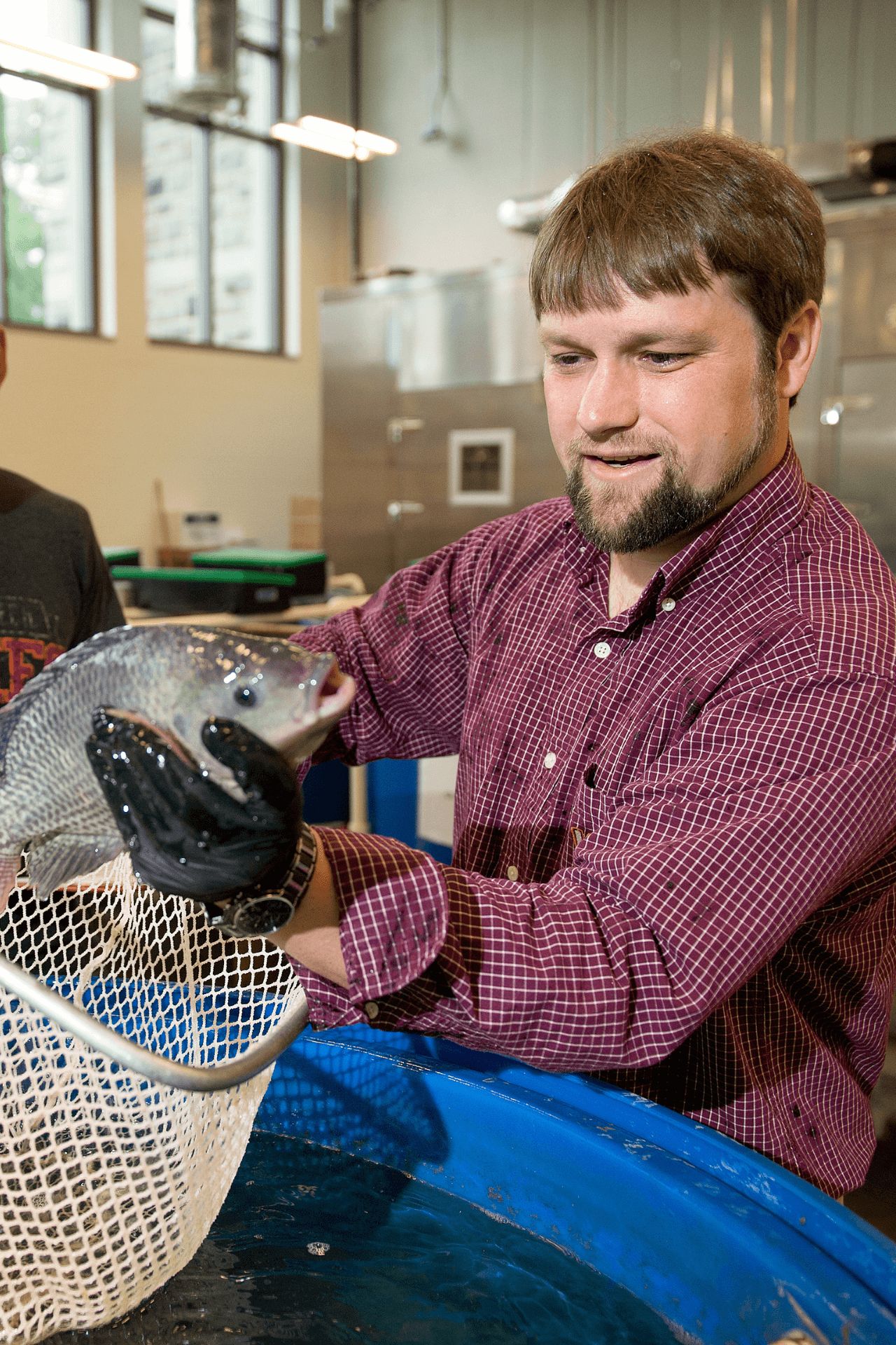 A researcher holds up a fish