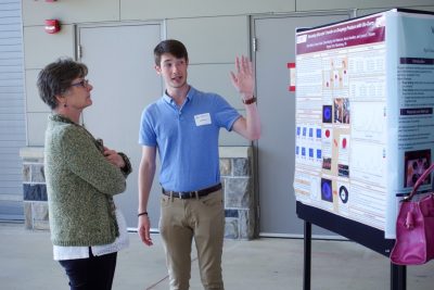 Jakob Baker discusses his research with a judge at the annual FST Student Poster Competition