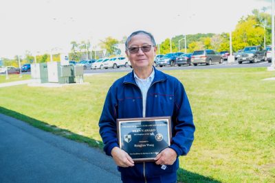 Dr. Hengjian Wang poses with his CALS 2023 Employee of the Year award