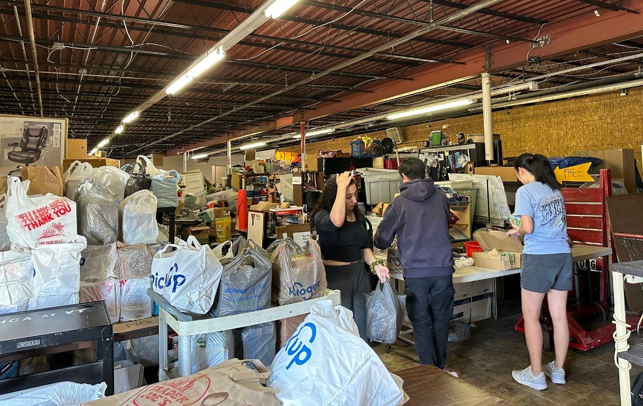 Bags of food line an active workshop.