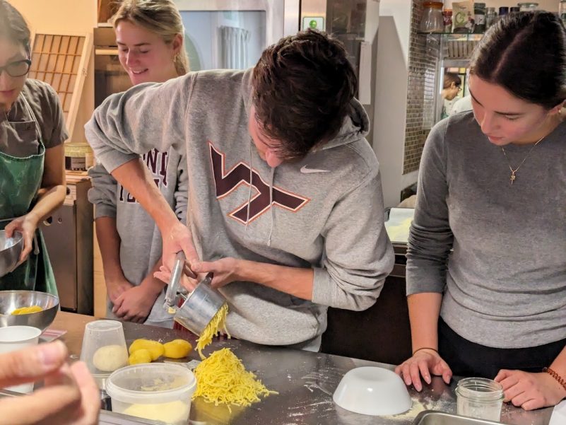 students making past in kitchen
