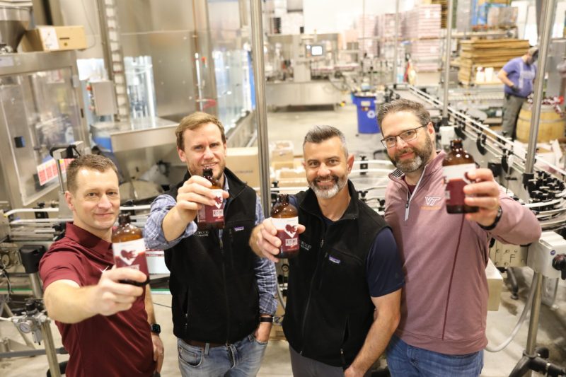 FST's Brian Wiersema poses with Hardywood employees and Fightin' Hokies Lager